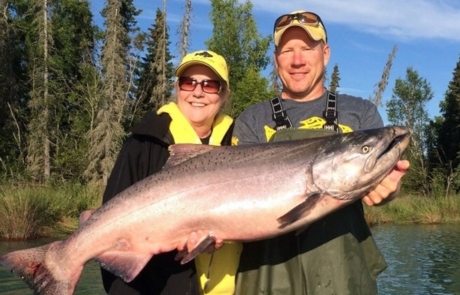 Guest and guide holding large salmon during an Alaskan fishing trip.