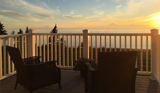 chairs on balcony overlooking sunset