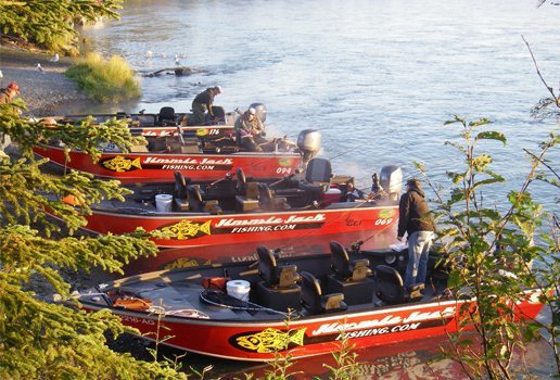 four fishing boats lined up on the shore