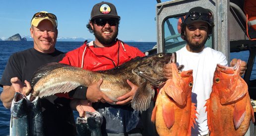 Three fishing guides posing with fish.