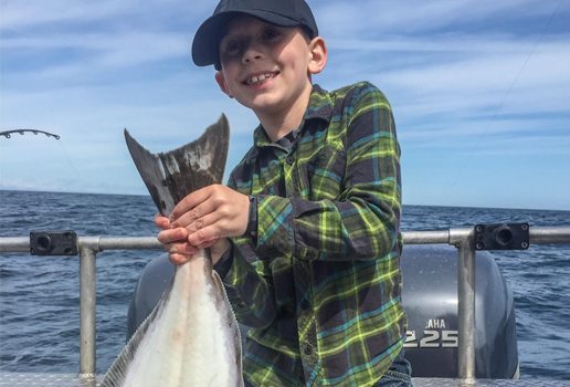 Young boy holding a fish