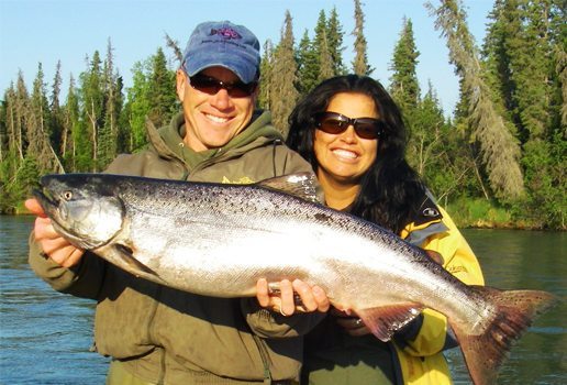 Jimmie and lady guest holding a large salmon