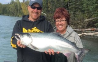 Woman and guide holding a salmon