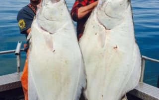 Rain and Raid holding large halibut