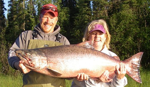 guest and guide holding large salmon