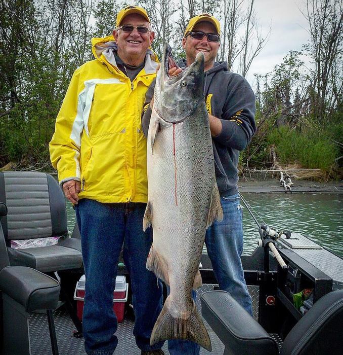 Guide and guest holding a huge salmon