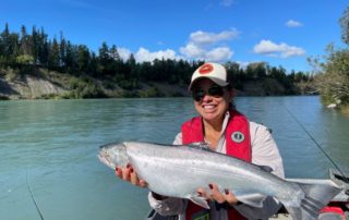 Rosy holding large silver salmon. "Kenai River Silver Salmon Fishing."