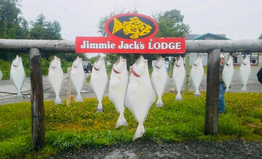 dozen halibut hanging on Jimmie Jack's sign
