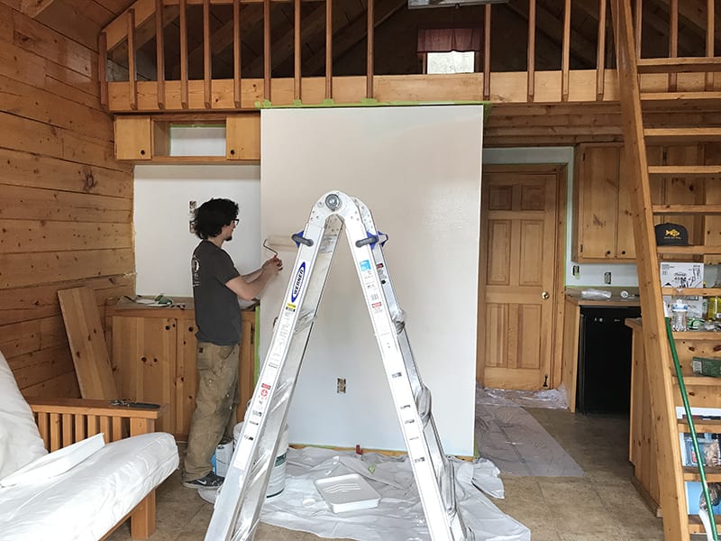 person working on remodeling cabin