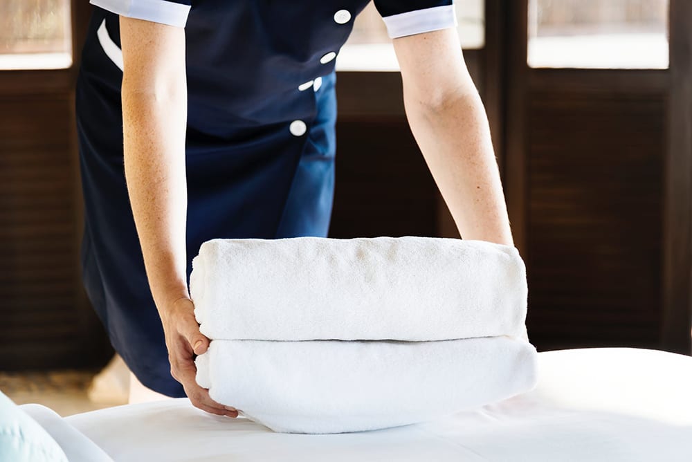 Housekeeper handling towels