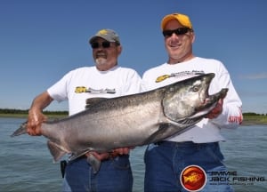 A proud angler holds up is latest bounty with the aid of an elite Alaskan fishing guide.