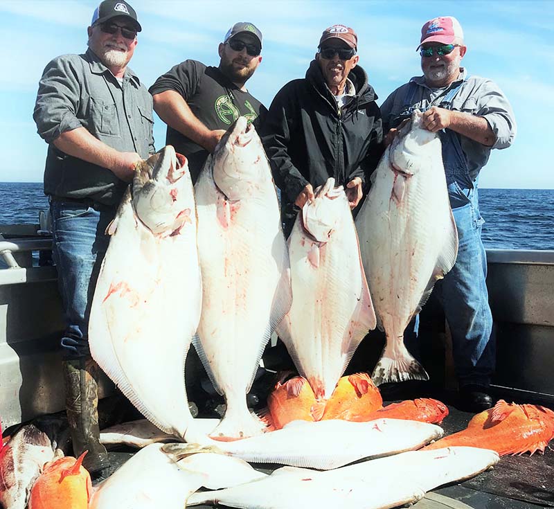 Group of men with rockfish catch.