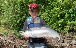 Young boy holding a fish