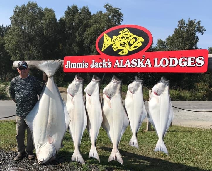 Halibut hanging on sign.