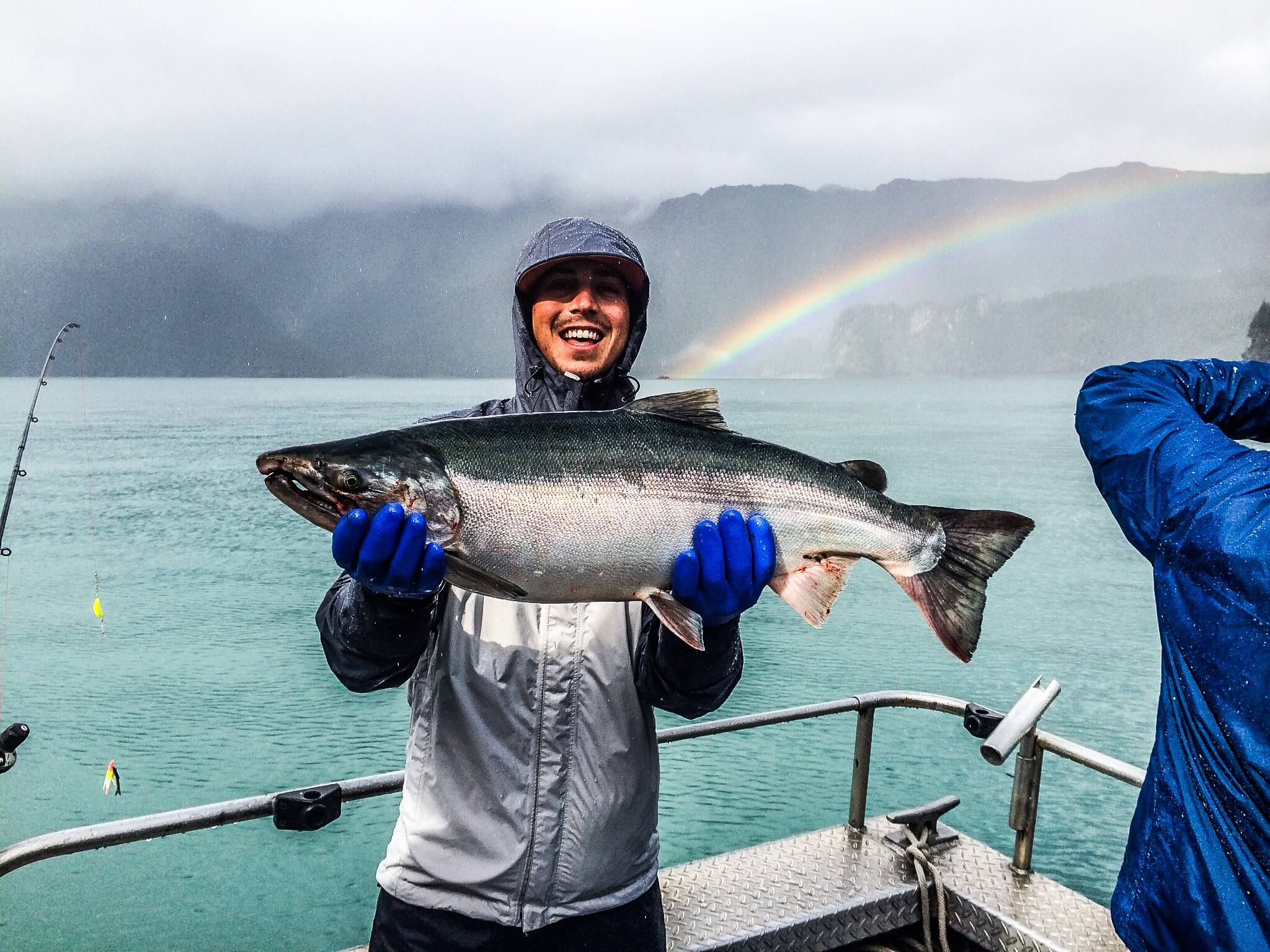 A happy fisherman holds up a massive salmon caught in the Cook Inlet.
