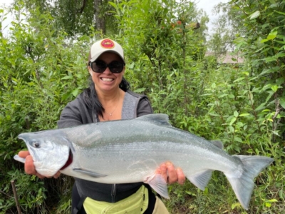 woman holding a large salmon