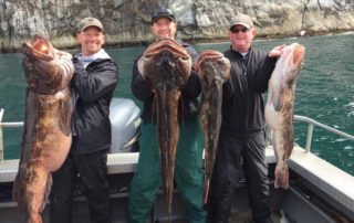 A trio of anglers shows off the rockfish they caught during an Alaska fishing adventure.