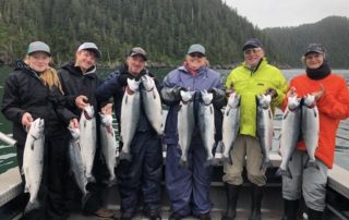 A group of anglers shows off their haul from a Kenai River fishing trip.