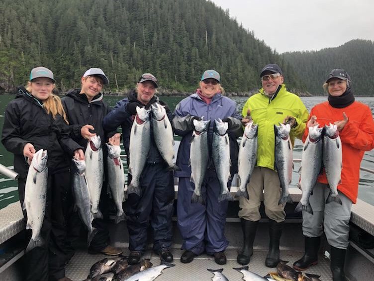 A group of anglers shows off their haul from a Kenai River fishing trip.
