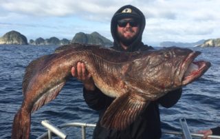 Alaska Lingcod: An avid angler proudly holds a massive lingcod caught in Alaska.