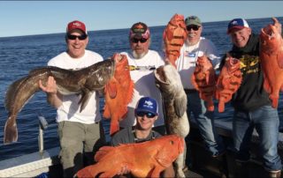 Alaska Fishing Charters: A group of anglers hold up several large rockfish and lingcod.